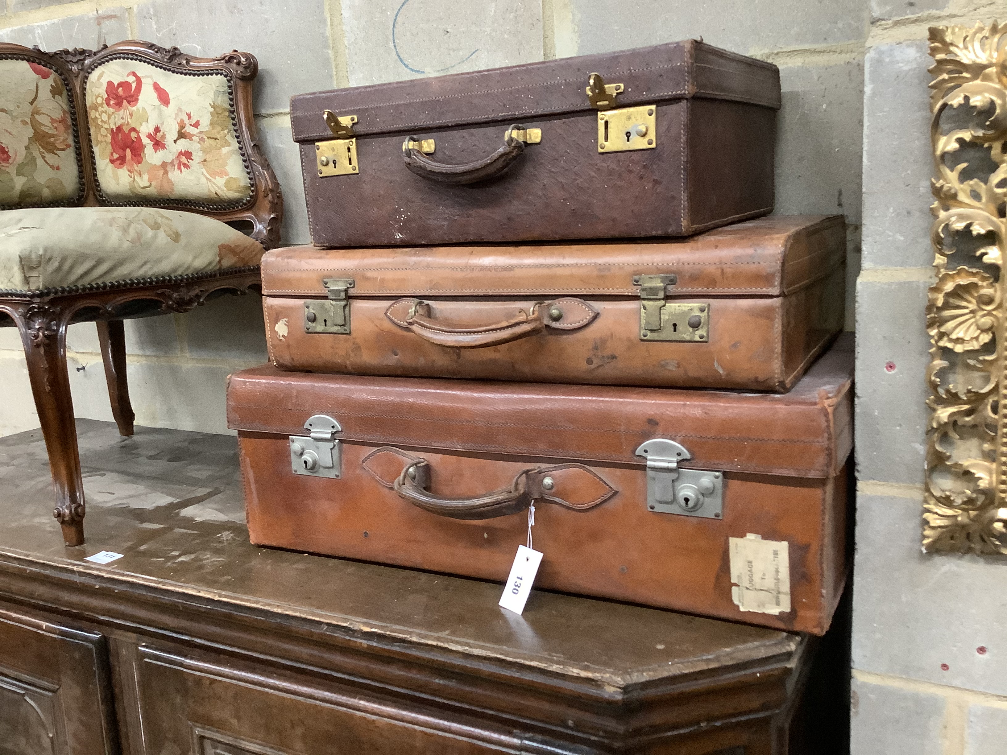 Three vintage leather suitcases, largest width 76cm, depth 45cm